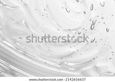 Clear gel serum texture. Liquid skincare cream background. Cosmetic gel product with bubbles close up Royalty-Free Stock Photo #2142656637
