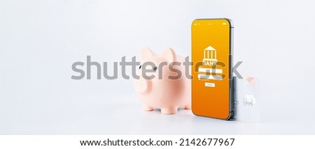 Internet based banking. Mobile phone with internet online bank app. Pig bank with credit card on white background. Online wallet save money