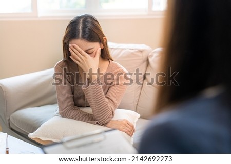 Stressed Asian teens are treated by a psychologist or psychiatrist in a psychiatric clinic or hospital. Patients reported symptoms of depression, stress, irritability, and life problems. Royalty-Free Stock Photo #2142692273