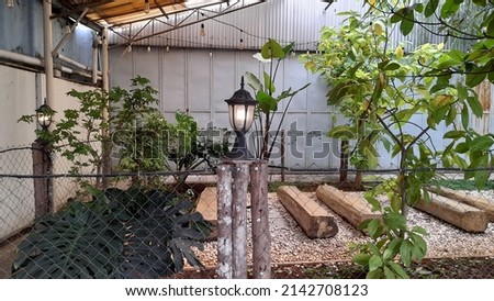 a coffee shop restaurant with an open air concept with interior lamps and trees. building interior background concept, exterior, design, lifestyle, gardening, garden, agriculture, natural, landscape