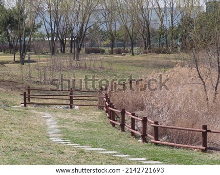 between winter and spring, fence in a field