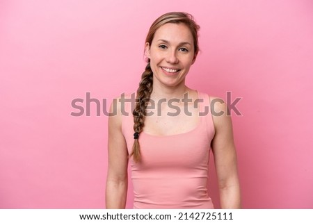 Young caucasian woman isolated on pink background laughing