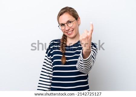 Young caucasian woman isolated on white background doing coming gesture