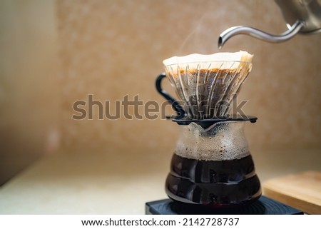 Making pour over coffee with dripper and carafe Royalty-Free Stock Photo #2142728737