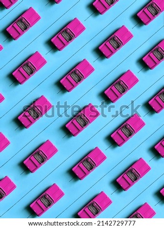 Pattern of vintage children's cars on a blue road. Background of toy retro cars.