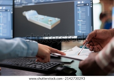 Close up of creative industry employees with clipboard and advanced 3D modeling software open in background. 3D digital artists reviewing sketch scene plan and simulated render times, Royalty-Free Stock Photo #2142730293