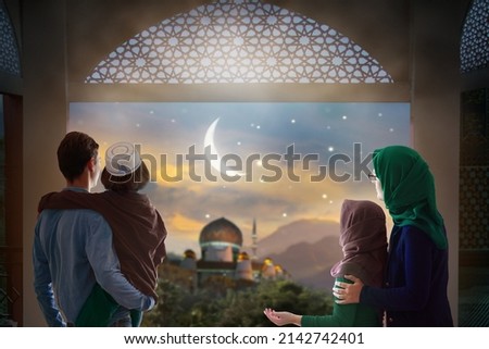 Ramadan Kareem greeting. Family at window looking at Islamic city with mosque skyline, crescent moon and stars. Muslim parents and children pray. Mother, father and kids celebrate end of fasting.  Royalty-Free Stock Photo #2142742401