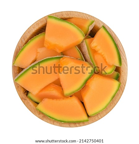 Cantaloupe melon pieces in wooden bowl isolated on white background with clipping path and full depth of field. Top view. Flat lay Royalty-Free Stock Photo #2142750401