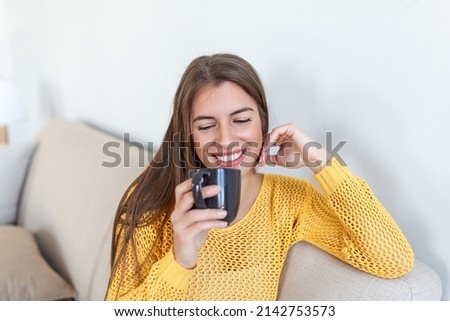 Closeup view of young woman with cup of hot drink at home, blank space. People, drinks and leisure concept - happy young woman with cup of tea or coffee at home