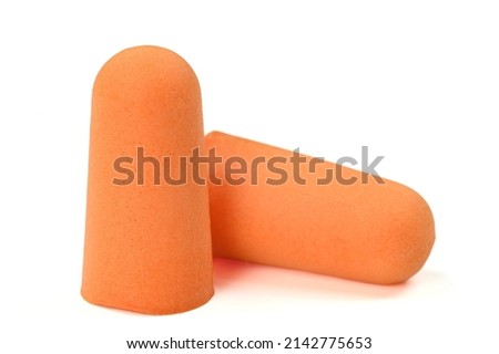 Soft orange foam earplugs isolated on a white background.Close-up.The concept of getting rid of noise in a loud place, hearing protection.High quality photo