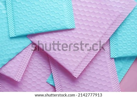  pink and green color paper bubble envelope on table  Royalty-Free Stock Photo #2142777913