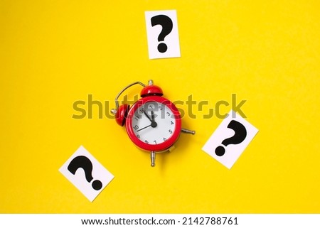 a question mark on a yellow background and a red alarm clock . FAQ frequency asked questions, Answer and Brainstorming Concepts.