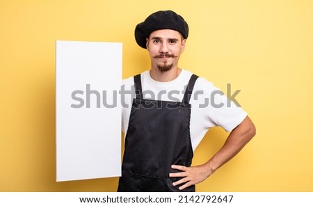 artist man smiling happily with a hand on hip and confident. copy space concept