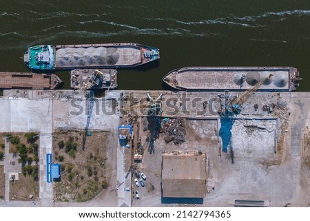 Nikopol river port from above. Photo of barges in the water.
Summer sunny day.