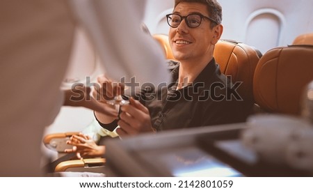 cabin crew working on plane. cabin crew service passenger, Air hostess service on plane. Excellent service from airlines. Happy travel by plane. Happy passenger, Safety flight, Bon voyage. Royalty-Free Stock Photo #2142801059