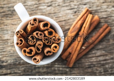 Dry cinnamon sticks on a wooden table. Top view. Cinnamon spice.