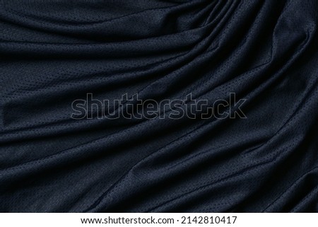 Sport clothing fabric texture background. Navy blue fabric sport clothing football jersey with air mesh texture background. Top view