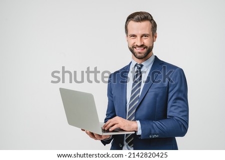 Successful young confident businessman using laptop for e-learning, remote work, watching webinar application online isolated in white background Royalty-Free Stock Photo #2142820425
