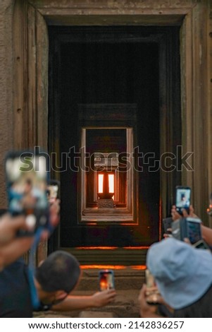 The sun shines through the door of the stone castle and strikes the Shiva Lingam representing Lord Shiva at Phanom Rung Historical Park                                Royalty-Free Stock Photo #2142836257