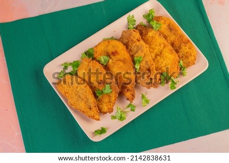 Different angle of a chicken pane plate, chicken breasts, a well known family meal in Egypt. Especially in the month of Ramadan. 
The chicken first seasoned for a couple of hours then fried in oil.  Royalty-Free Stock Photo #2142838631