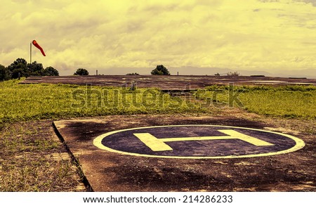 Heliport on peak of mountain with cloud sky in retro tone