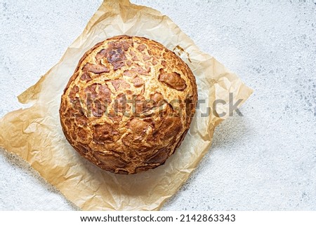 Fresh crispy Tiger (Dutch) bread with a delicious beautiful crust and wonderful homemade taste on a light background. Bakery product with cracks.