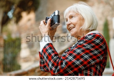 Portrait of senior woman smiling in city