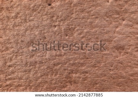 Textured brushed metallic background in copper color.