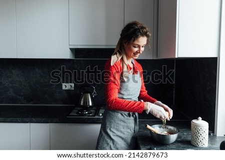 woman cook prepares food in kitchen