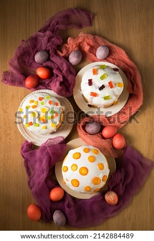 Easter cakes decorated with candied fruits and jelly sweets and kumquat, top view