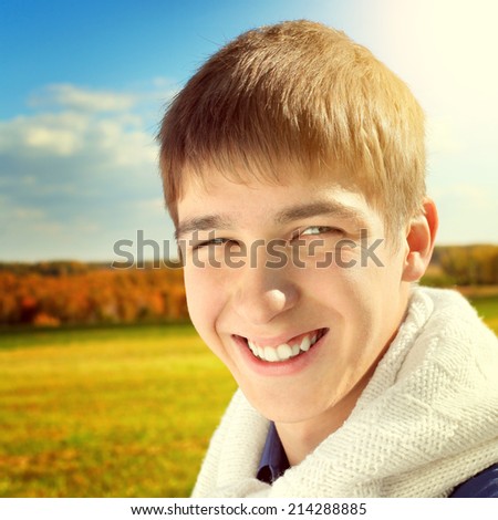 Toned photo of Happy Teenager Portrait at the Autumn Field