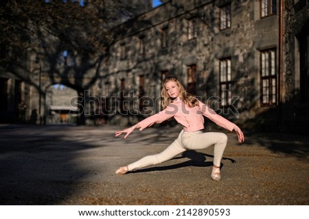 Elegant ballet dancer young girl dancing ballet outdoors. Ballet in the streets