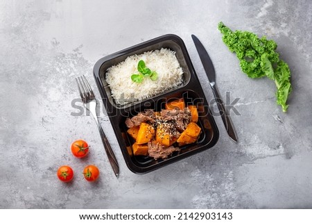 a dish in a black disposable container from catering on a concrete background, dietary catering, ready meals with you, healthy food Royalty-Free Stock Photo #2142903143