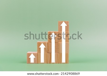 Business growth concept with arrow on green background