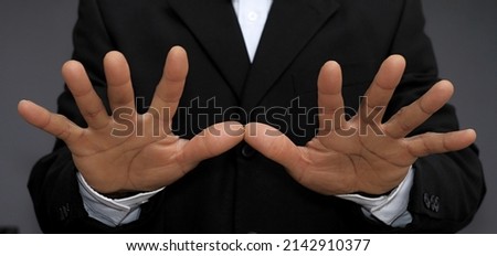 men giving hand gesture with grey background stock photo