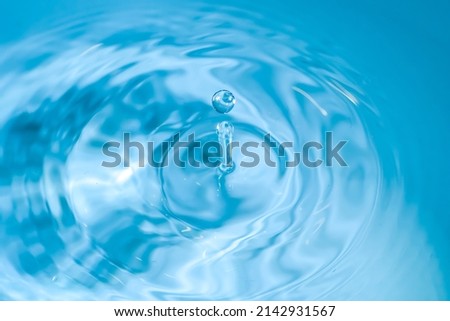 water drop splash blue colored. Round water drop. Water drop in glass. Drops, splashes, spray, abstract shapes out of the water Royalty-Free Stock Photo #2142931567