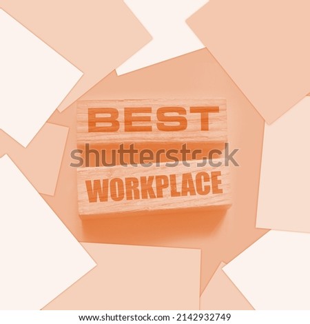 Hand of a businessman holding wooden blocks. Conceptual image. Text BEST WORKPLACE. concept business succeed.
