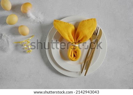 Beautiful festive Easter plates and napkin Bunny, eggs decorate, top view, copy space