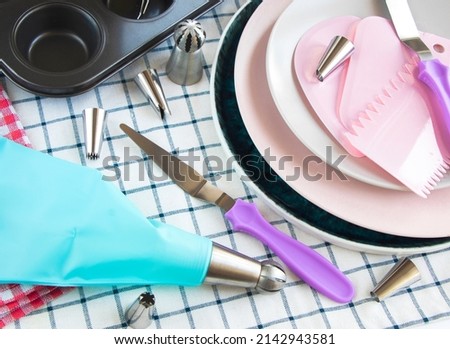 colorful kitchen utensils. tools for creating and decorating a cake, various cream tips . set of pastry spatulas. Pastry bag cream blue injector for cake dessert decoration, supplies kit icing piping Royalty-Free Stock Photo #2142943581