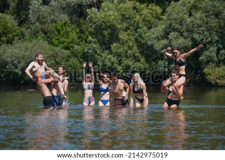 Young people cooling of in the river on hot summer vacation, Group picture photo of friends, guys and girls