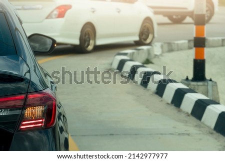 Rear side of cars on the road. Stop and open light brake with turn signal light. for U-turn on the asphalt road. With other cars on the front.
