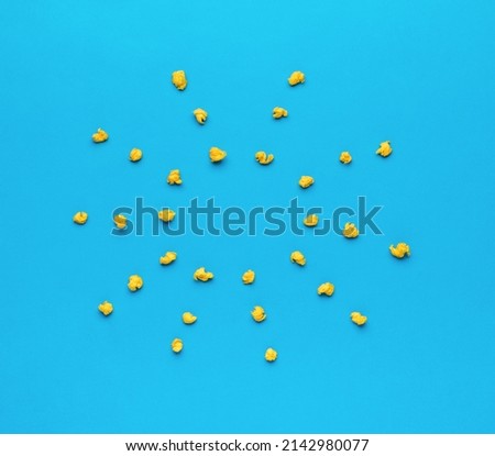 Crumpled balls of paper in the form of a sun on a blue background. Minimal business concept. Flat lay.