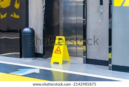 repair in progress sign near an lift, warning sign Royalty-Free Stock Photo #2142985875