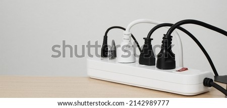 Electrical appliances plugs full of all plugs or plugs together. Because of the risk of causing a short circuit from high heat accumulated in the wires. Royalty-Free Stock Photo #2142989777