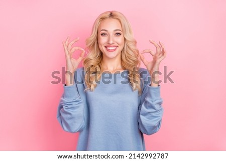 Photo of young pretty lady show fingers okey symbol great approve promoter isolated over pink color background