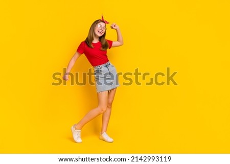Full size photo of carefree cheerful teen female having fun dancing discotheque isolated on yellow color background