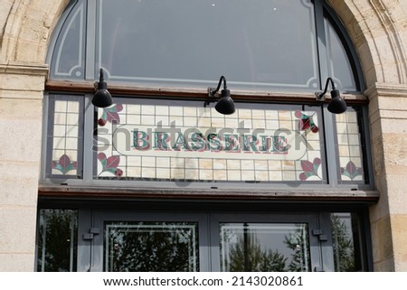 brasserie restaurant text sign paint on wall facade french building city street