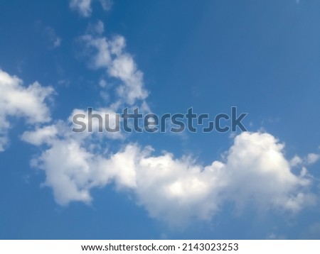 Beautiful white clouds on deep blue sky background. Elegant blue sky picture in daylight. Tiny small soft white fluffy clouds in the blue sky background. Cumulus clouds in clear blue sky. No focus