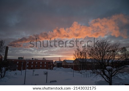 Panoramic view of beautiful winter wonderland scenery in scenic golden evening light at sunset with clouds in Scandinavia, northern Europe. Industrial pollution.