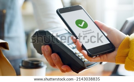 Customer using smartphone for NFC payment at cafe restaurant, cashless, contactless technology and money transfer concept Royalty-Free Stock Photo #2143038835